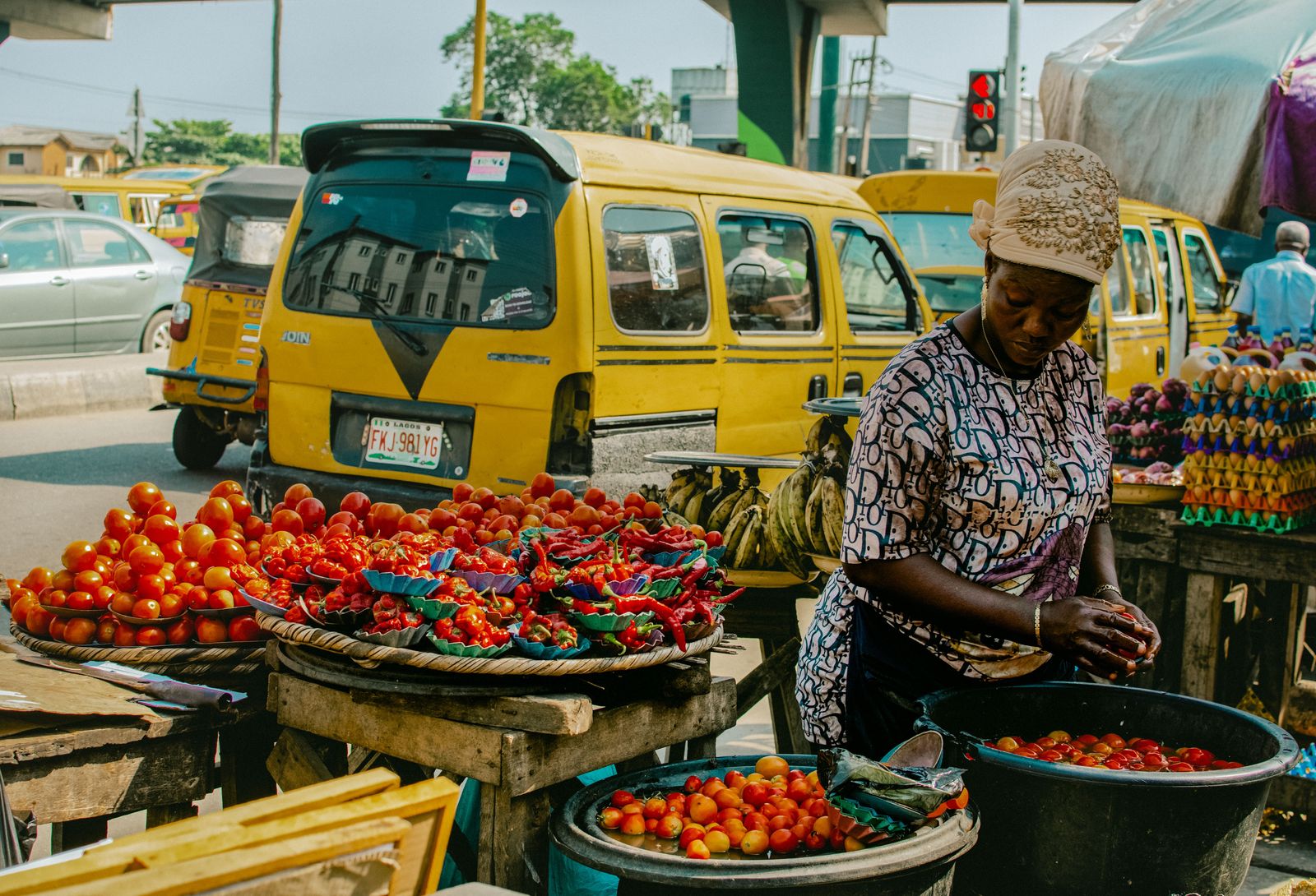 Market traders and a yellow minibus in Lagos, Nigeria